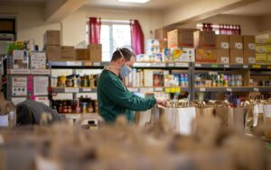 Man packing bags of food for donation.